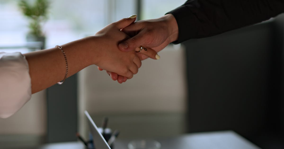 Two business people shaking hands during a meeting
