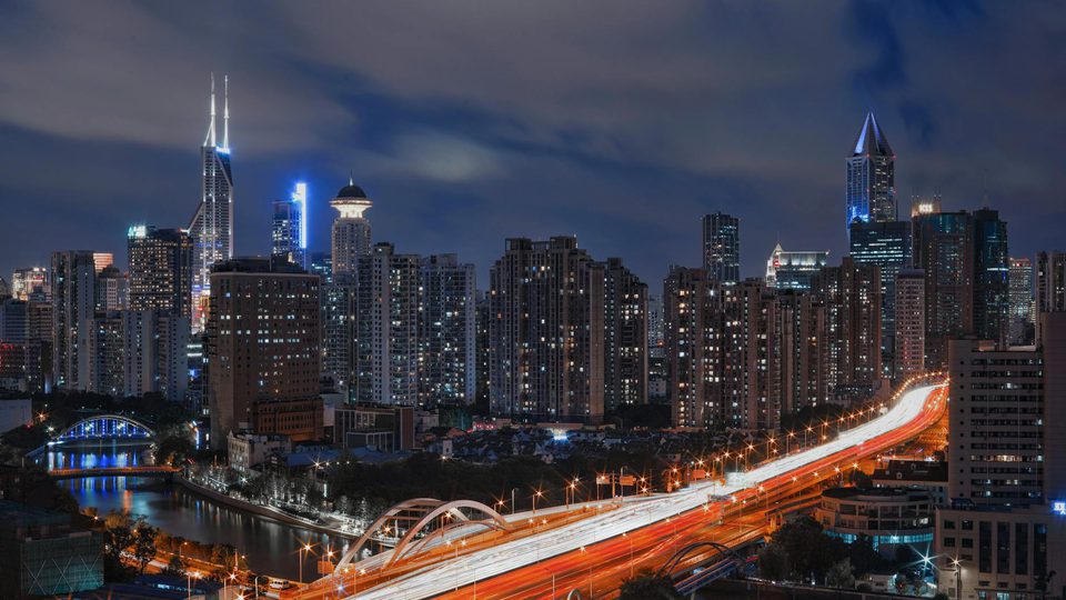 A city skyline illuminated at night.