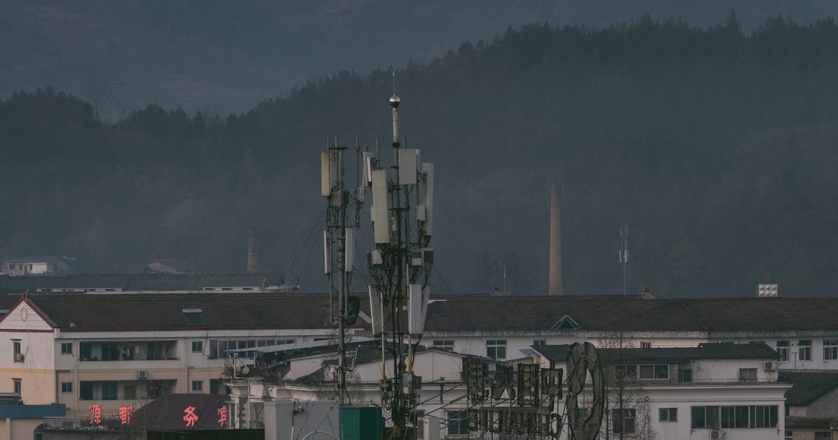 Telecommunication tower on a rooftop in an urban low-altitude environment