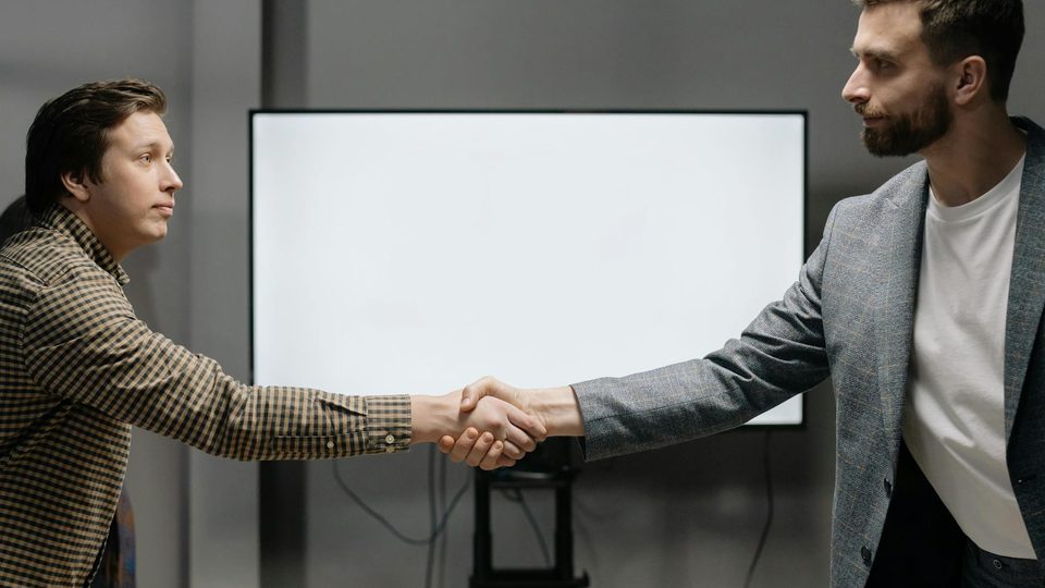 Business contract meeting for electro-optical equipment cooperation.